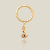 Piercing de aro Huggie con forma de gota de ojo malvado con circonita cúbica de zafiro